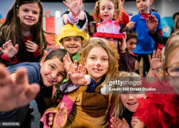 students in circus costumes performing in theater - zirkus kinder stock-fotos und bilder