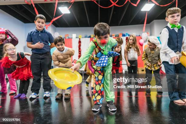 students in circus costumes bowing in theater - zirkus kinder stock-fotos und bilder