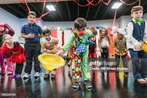 students in circus costumes bowing in theater - bowing_(social) stock pictures, royalty-free photos & images