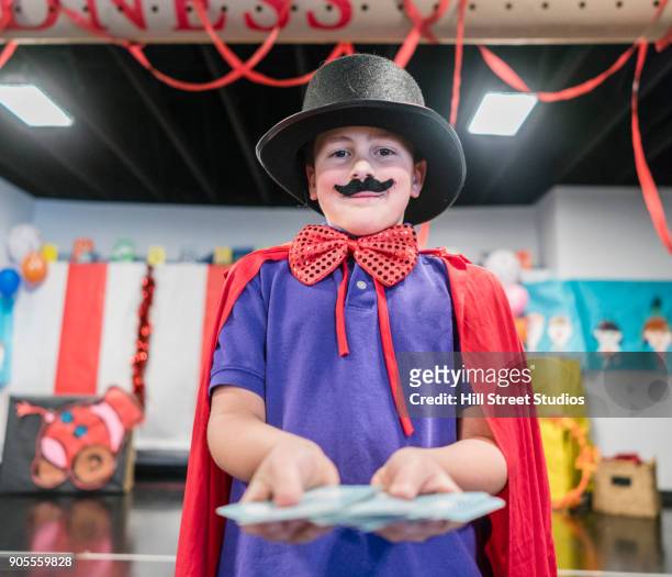 magician boy performing in theater circus - magician cards stock pictures, royalty-free photos & images