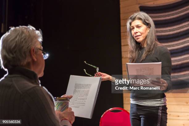 hispanic man and woman reading scripts on theater stage - scenario stockfoto's en -beelden