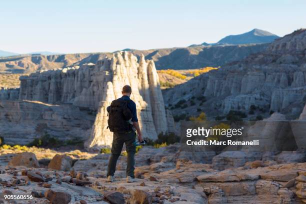 caucasian man carrying backpack in desert - abiquiu foto e immagini stock