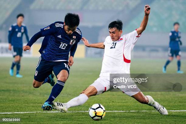 Hatate Reo of Japan and Kim Nam-Il of North Korea compete for the ball during the AFC U-23 Championship Group B match between Japan and North Korea...