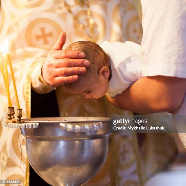 caucasian baby girl being baptized - dopen stockfoto's en -beelden