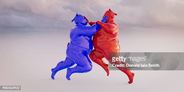 red and blue sumo wrestlers fighting - desporto de combate imagens e fotografias de stock