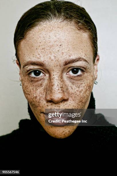 close up of serious mixed race woman - freckle stock pictures, royalty-free photos & images