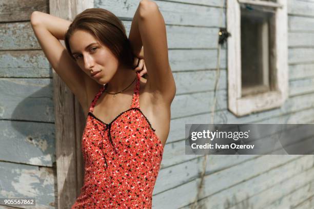 serious caucasian woman standing near corner of house - simferopol stock pictures, royalty-free photos & images