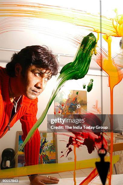 Painter Niladri Paul displays the process of colour therapy using a pendulum in New Delhi, India