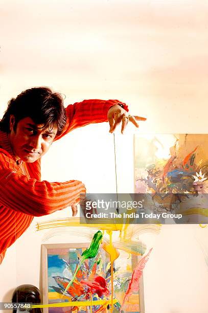 Painter Niladri Paul displays the process of colour therapy using a pendulum in New Delhi, India