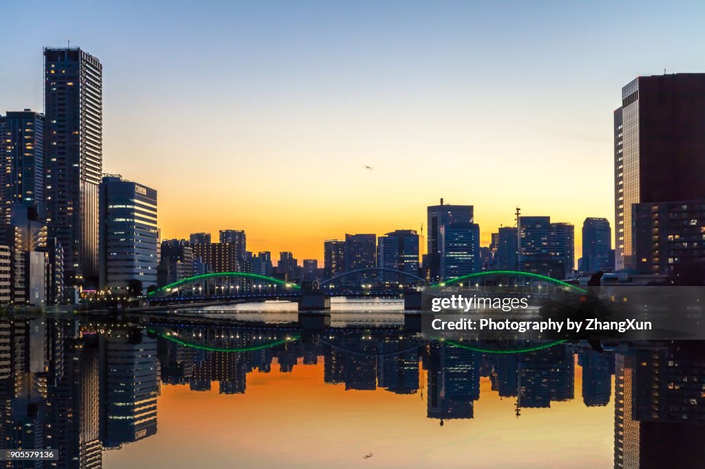 Reflection view of Tokyo waterfront cityscape at sunset, chuo ward, Tokyo, Japan.