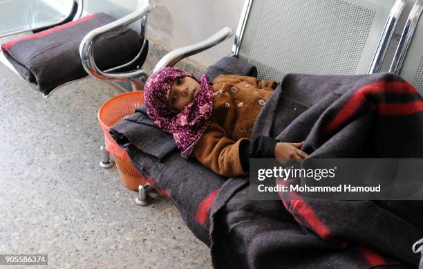 Yemeni malnourished girl receives medical treatment as she lays on an chair at the corridor at a malnutrition center amid increasing threats of...