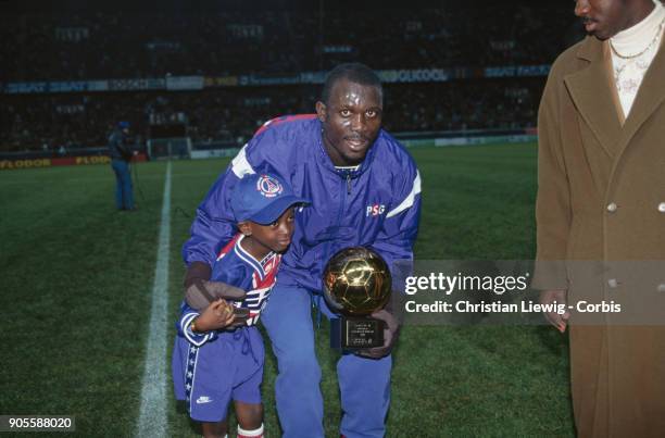 Liberian Soccer Player George Weah with his son George Jr. - P.S.G./Nantes - France Championship 94/95