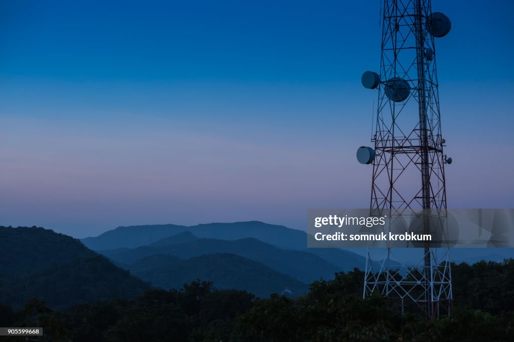 Mountain range with commuication in twilight time after sun set