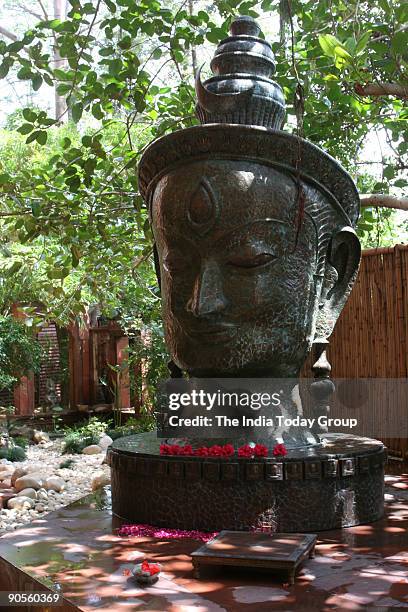 Satish Gupta, Painter sitting infront of Shiva Statue at his house in DLF Gurgaon, Haryana, India