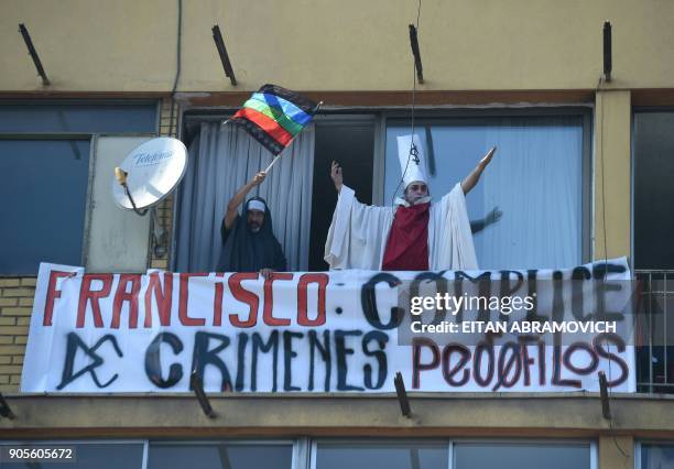 People demonstrate against the visit of Pope Francis to Chile for the Church's child sexual abuse scandal as one flutters a Mapuche flag, in the...