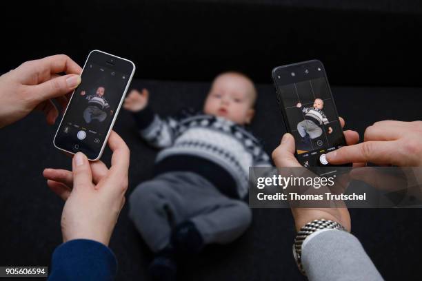 Berlin, Germany Symbolic photo on the topic of education: A baby is photographed with two smartphones on January 16, 2018 in Berlin, Germany.