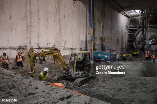 Construction workers carry out cement reinforcement work inside a tunnel during a tour of the Paris Metro subway railway line 12 Grand Paris...