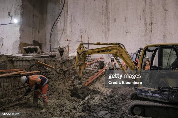 Construction workers carry out cement reinforcement work inside a tunnel during a tour of the Paris Metro subway railway line 12 Grand Paris...