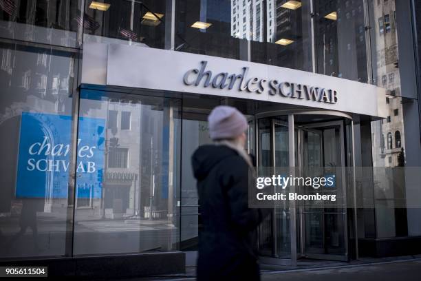 Pedestrian passes in front of a Charles Schwab Corp. Bank branch in downtown Chicago, Illinois, U.S., on Monday, Jan. 8, 2018. Charles Schwab Corp....