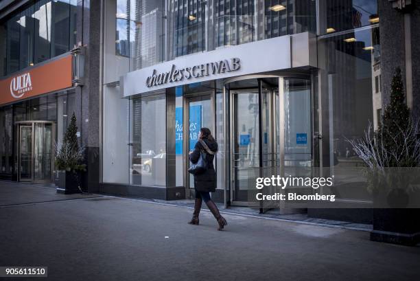 Pedestrian passes in front of a Charles Schwab Corp. Bank branch in downtown Chicago, Illinois, U.S., on Monday, Jan. 8, 2018. Charles Schwab Corp....