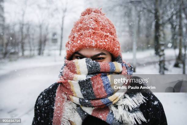 a young woman enjoying snowfall in amsterdam - cold woman stock-fotos und bilder
