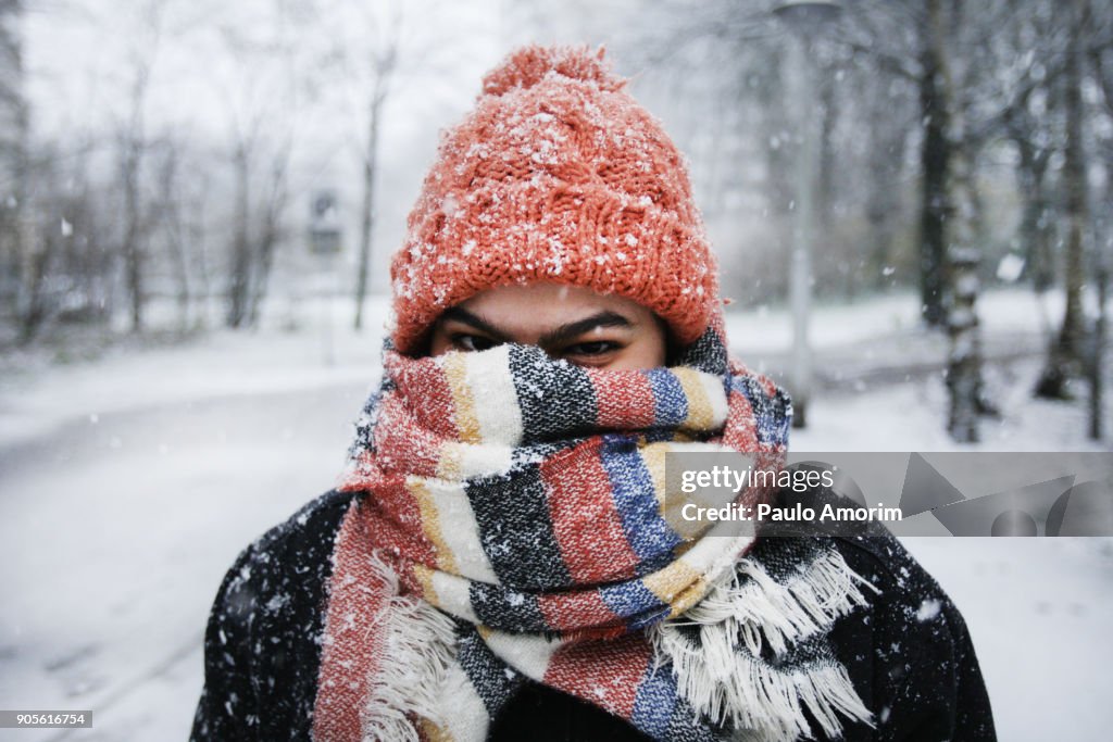 A young woman enjoying snowfall in Amsterdam