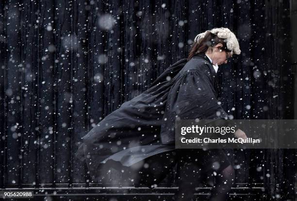 Barrister makes her way into Belfast High Court through heavy snow on January 16, 2018 in Belfast, Northern Ireland. The Met Office has placed an...