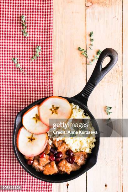 pork stew with dried cranberry served with couscous in a pan, selective focus - homemade apple sauce stock pictures, royalty-free photos & images