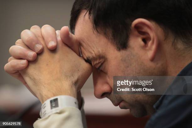 Larry Nassar listens to victim impact statements prior to being sentenced after being accused of molesting about 100 girls while he was a physician...