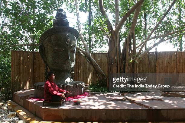 Satish Gupta, Painter sitting infront of Shiva Statue at his house in DLF Gurgaon, Haryana, India