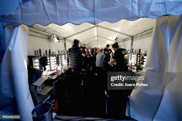 Makeup artists work backstage ahead of the Riani show during the MBFW January 2018 at ewerk on January 16, 2018 in Berlin, Germany.