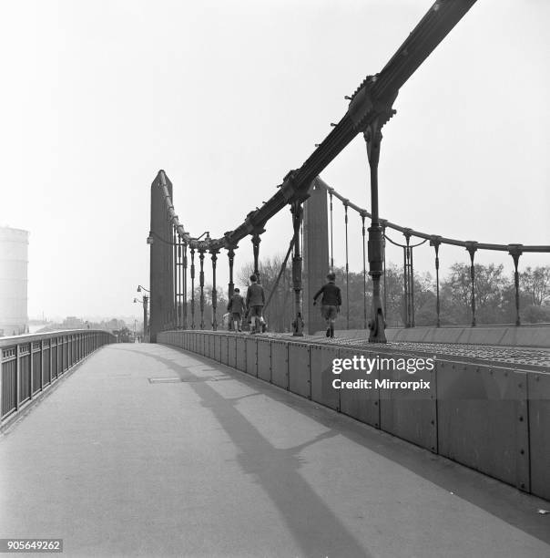 Children playing on Albert Bridge, London, 25th May 1954.