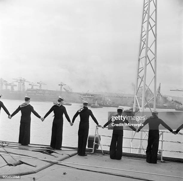 Ark Royal is launched at Cammell Laird shipyard, Birkenhead, Merseyside, 3rd May 1950. Sailors holding hands on deck of HMS Illustrious.