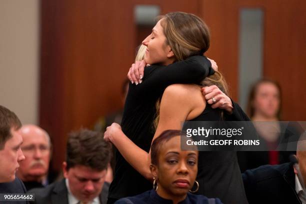 Kyle Stephens, a victim of former Team USA doctor Larry Nassar, gets a hug following her victim impact statement during a sentencing hearing in...