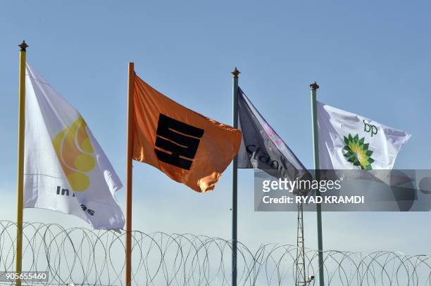 Picture taken on January 16, 2018 at In Amenas gas plant 300 kilometres southeast of Algiers, shows flags of various companies during a ceremony to...