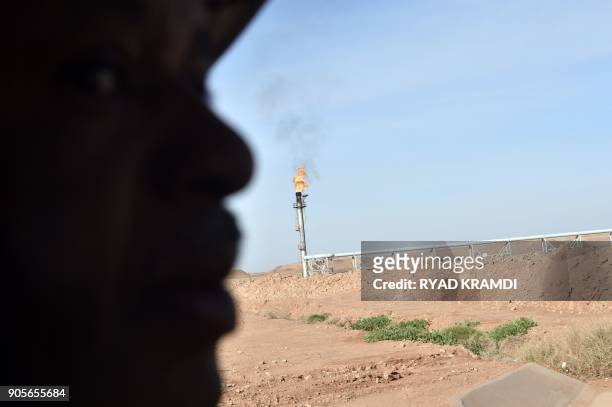 Picture taken on January 16, 2018 at In Amenas gas plant 300 kilometres southeast of Algiers, shows a worker at the site during a ceremony to mark...