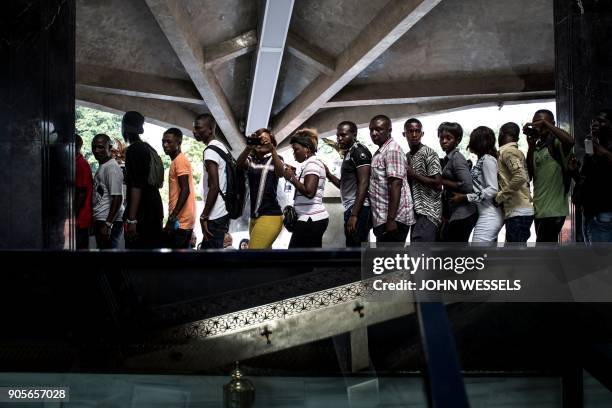 Supporters of the current President of the Democratic Republic of the Congo take turns to see the tomb of current President's father and former...