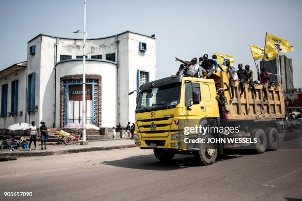 Supporters of the current President of the Democratic Republic of the Congo parade through the city on a truck during celebrations marking the 17th...