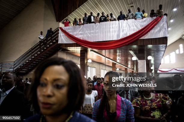 Supporters of the current President of the Democratic Republic of the Congo attend a mass during celebrations marking the 17th anniversary of the...