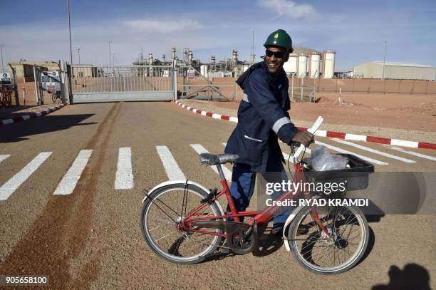 Picture taken on January 16, 2018 at In Amenas gas plant 300 kilometres southeast of Algiers, shows a worker riding a bike at the site following a...