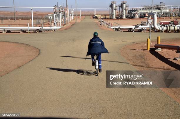 Picture taken on January 16, 2018 at In Amenas gas plant 300 kilometres southeast of Algiers, shows a worker riding a bike at the site following a...
