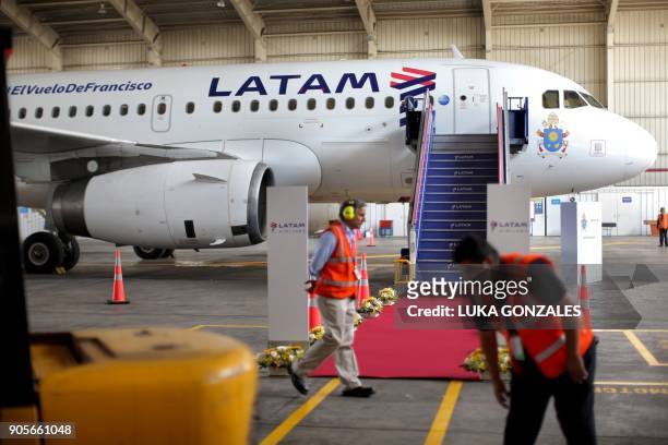 Airlines personnel work in the preparations for the official presentation of the Airbus A319, which will transport Pope Francis during his upcoming...