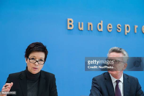 German Interior Minister Thomas de Maiziere and Head of the Federal Agency for Migration and Refugees Jutta Cordt attend a press conference at the...