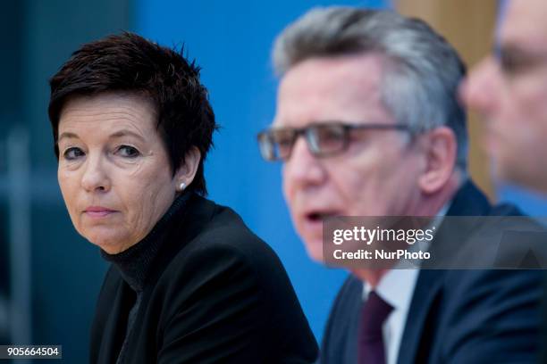 German Interior Minister Thomas de Maiziere and Head of the Federal Agency for Migration and Refugees Jutta Cordt attend a press conference at the...