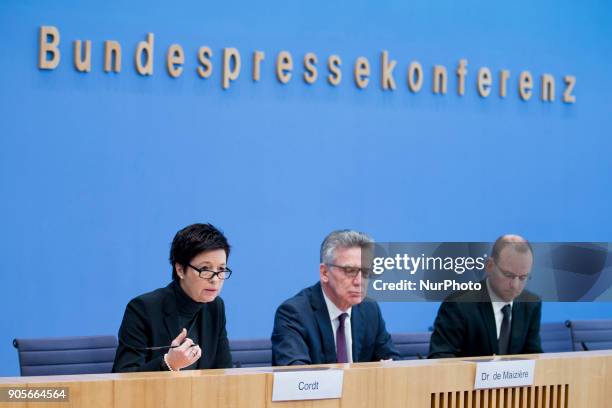 German Interior Minister Thomas de Maiziere and Head of the Federal Agency for Migration and Refugees Jutta Cordt attend a press conference at the...