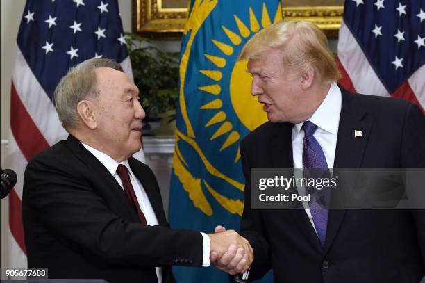 President Donald Trump shakes hands with President Nursultan Nazarbayev of Kazakhstan during a joint press conference in the Roosevelt Room of the...