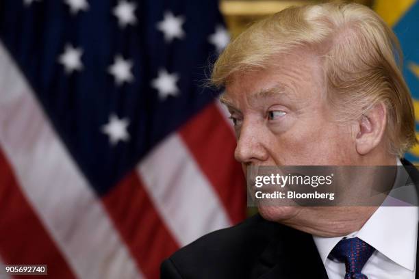 President Donald Trump listens while Nursultan Nazarbayev, Kazakhstan's president, not pictured, speaks during a joint press conference in the...