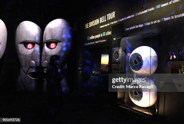 Visitors walk in front of a musical instruments collection during the 'The Pink Floyd Exhibition: Their Mortal Remains' at the MAXXI Museum in...