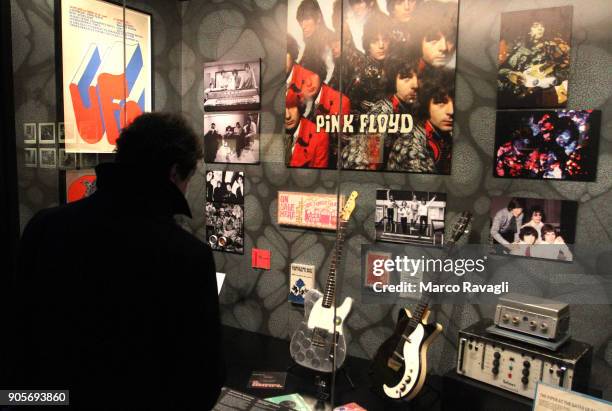 Visitors walk in front of a musical instruments collection during the 'The Pink Floyd Exhibition: Their Mortal Remains' at the MAXXI Museum in...