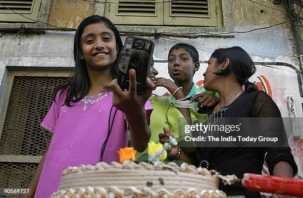 Puja with the camera poses in Sonagachi, the Red Light Area of Kolkata for press photographers along with her other photographer friends on whom the...